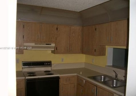 7921 Southgate Blvd Unit D5, North Lauderdale, FL 33068 - kitchen featuring under cabinet range hood, electric range oven, light countertops, and a textured ceiling