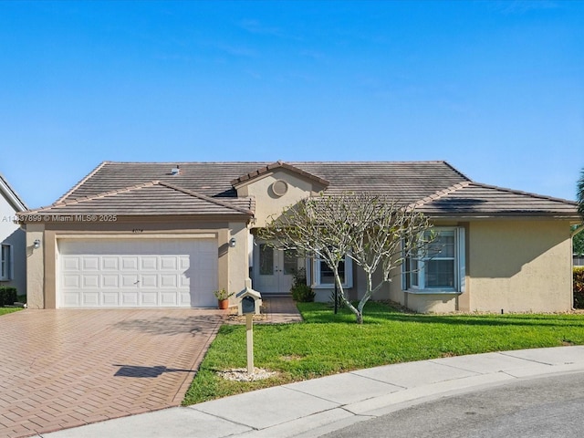 4024 Summer Chase Ct, Lake Worth, FL 33467 - view of front of house featuring stucco siding, an attached garage, and decorative driveway