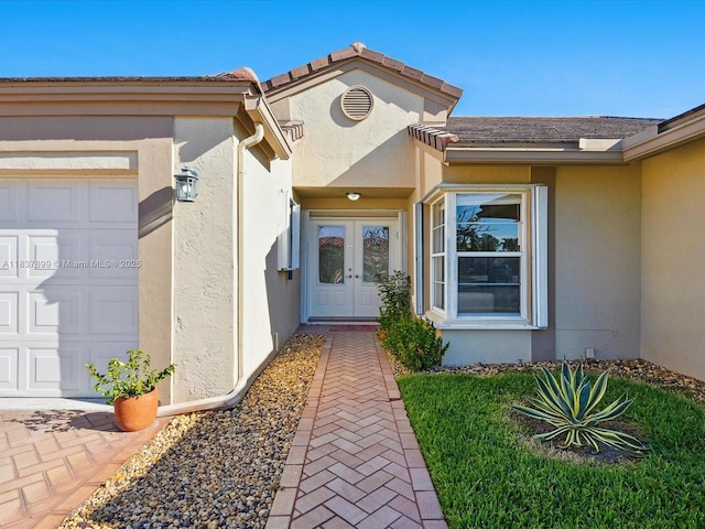 4024 Summer Chase Ct, Lake Worth, FL 33467 - property entrance with french doors, stucco siding, and an attached garage