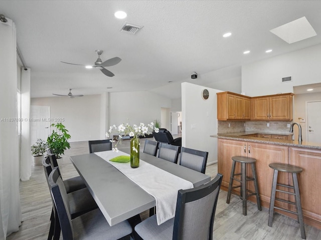 4024 Summer Chase Ct, Lake Worth, FL 33467 - dining area with light wood-type flooring, lofted ceiling, a ceiling fan, recessed lighting, and a skylight