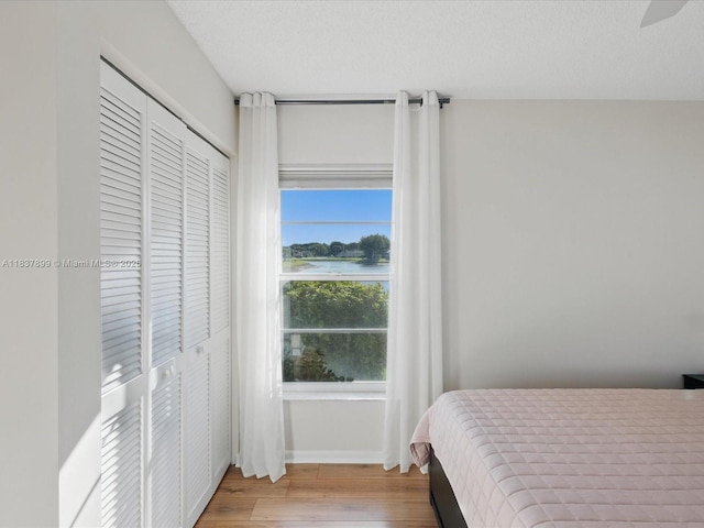 4024 Summer Chase Ct, Lake Worth, FL 33467 - bedroom featuring wood finished floors, a closet, a water view, and a ceiling fan