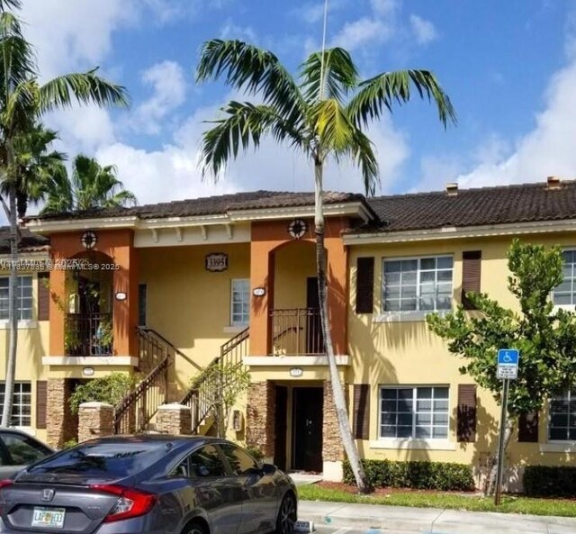 3395 NE 9th St Unit 104, Homestead, FL 33033 - view of front of property featuring stucco siding and stairway