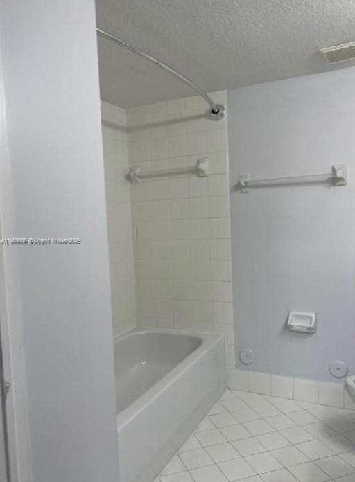 3395 NE 9th St Unit 104, Homestead, FL 33033 - full bath with tile patterned flooring, a textured ceiling, and shower / bath combination