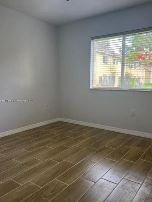 3395 NE 9th St Unit 104, Homestead, FL 33033 - empty room featuring wood finish floors and baseboards