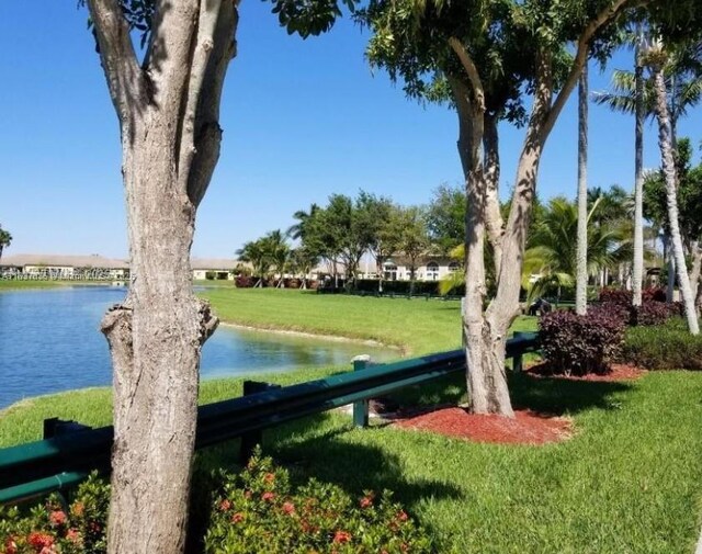 3395 NE 9th St Unit 104, Homestead, FL 33033 - surrounding community with a water view and a lawn