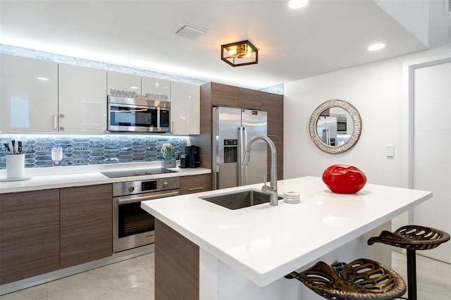 1010 SW 2nd Ave Unit Lph04, Miami, FL 33130 - kitchen with appliances with stainless steel finishes, modern cabinets, a breakfast bar area, light countertops, and recessed lighting
