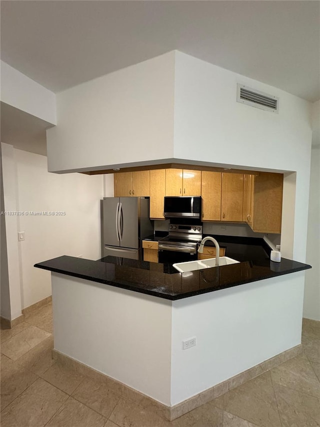 801 Brickell Key Blvd Unit 1005, Miami, FL 33131 - kitchen with appliances with stainless steel finishes, a peninsula, dark countertops, brown cabinetry, and light tile patterned floors