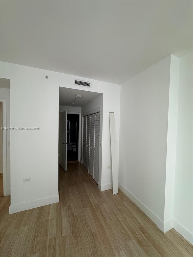 801 Brickell Key Blvd Unit 1005, Miami, FL 33131 - unfurnished room with light wood-style floors and baseboards