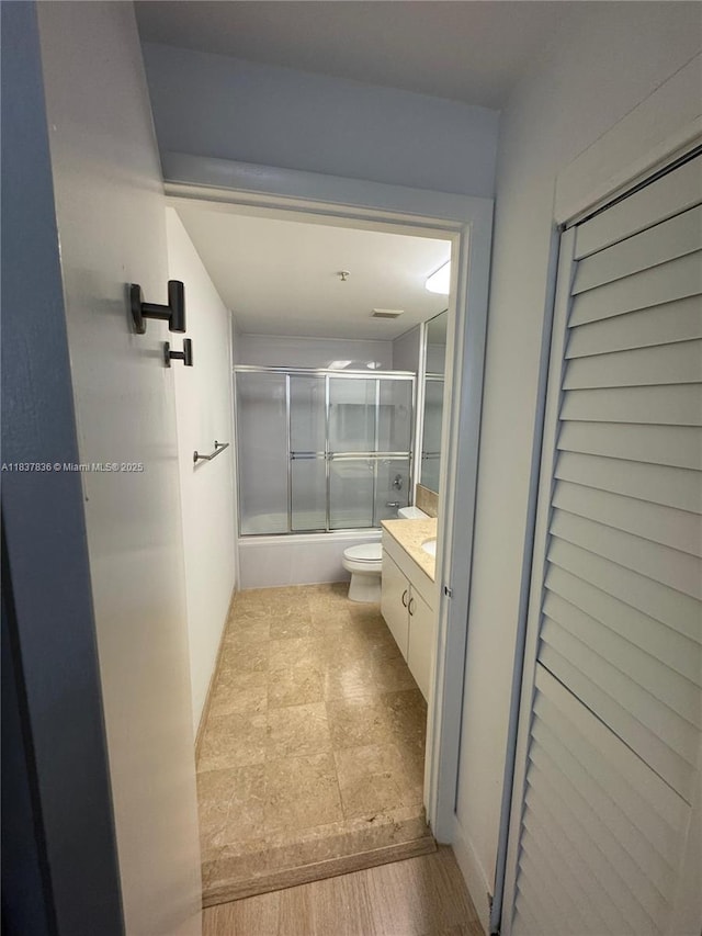 801 Brickell Key Blvd Unit 1005, Miami, FL 33131 - bathroom featuring shower / bath combination with glass door, vanity, and wood finished floors