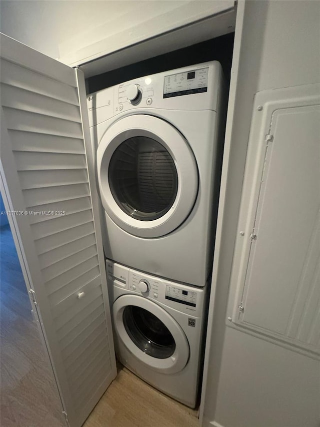 801 Brickell Key Blvd Unit 1005, Miami, FL 33131 - laundry area featuring stacked washing machine and dryer and wood finished floors