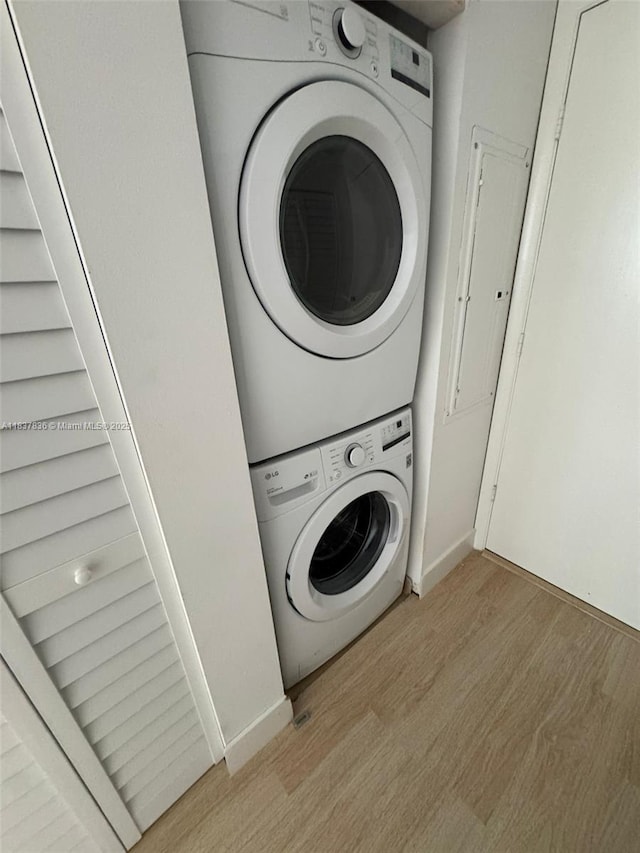 801 Brickell Key Blvd Unit 1005, Miami, FL 33131 - laundry room with stacked washing machine and dryer and wood finished floors