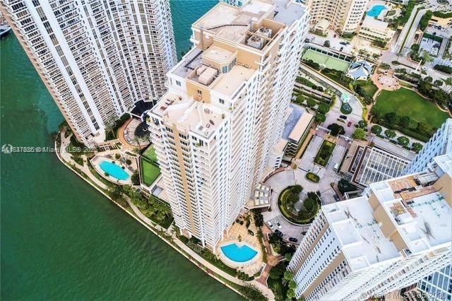 801 Brickell Key Blvd Unit 1005, Miami, FL 33131 - drone / aerial view of a pool area and a large body of water