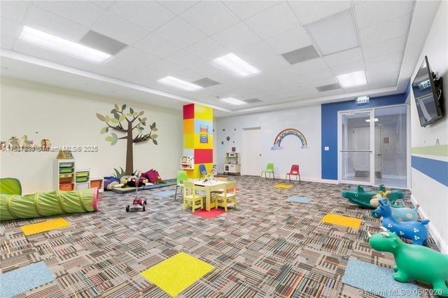 801 Brickell Key Blvd Unit 1005, Miami, FL 33131 - game room featuring a drop ceiling and carpet floors