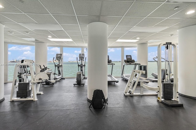 770 Claughton Island Dr Unit Ph21, Miami, FL 33131 - workout area featuring a wall of windows, a paneled ceiling, and a water view