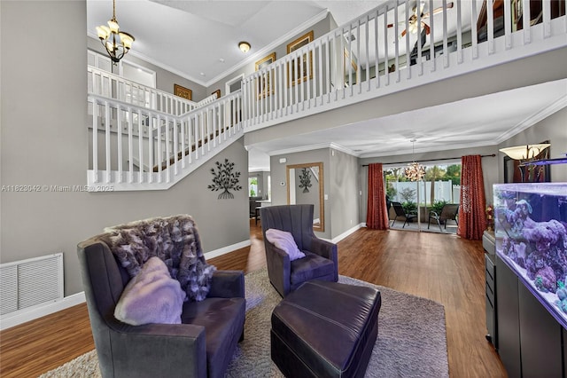 18205 NW 21st St, Pembroke Pines, FL 33029 - living area featuring a chandelier, crown molding, wood finished floors, and a high ceiling