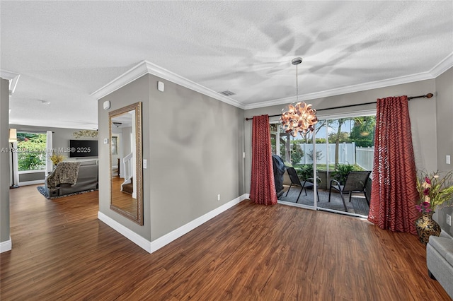 18205 NW 21st St, Pembroke Pines, FL 33029 - unfurnished dining area with wood finished floors, a textured ceiling, crown molding, and a chandelier