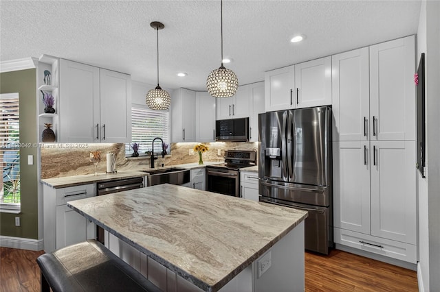 18205 NW 21st St, Pembroke Pines, FL 33029 - kitchen with appliances with stainless steel finishes, open shelves, healthy amount of natural light, light stone counters, and recessed lighting