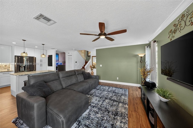 18205 NW 21st St, Pembroke Pines, FL 33029 - living room with ceiling fan, wood finished floors, stairs, a textured ceiling, and crown molding