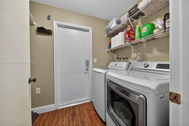 18205 NW 21st St, Pembroke Pines, FL 33029 - laundry area featuring washer and dryer, wood finished floors, and a textured ceiling