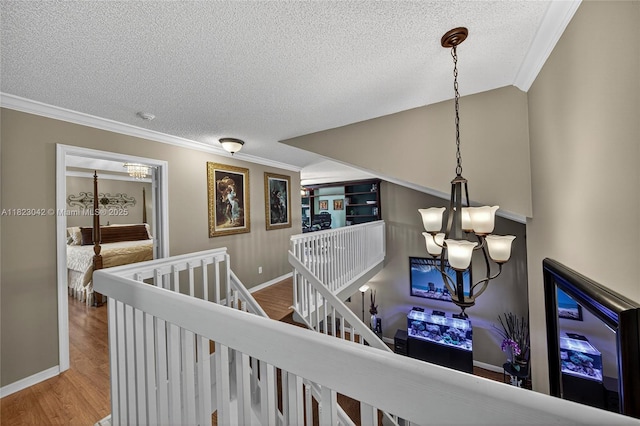 18205 NW 21st St, Pembroke Pines, FL 33029 - corridor with a chandelier, an upstairs landing, a textured ceiling, crown molding, and wood finished floors
