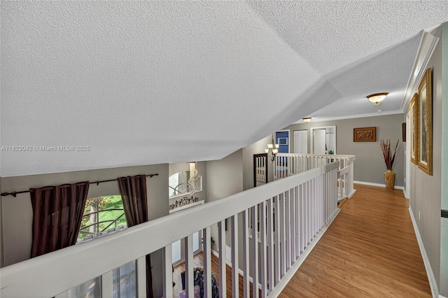 18205 NW 21st St, Pembroke Pines, FL 33029 - hall with a textured ceiling, wood finished floors, an upstairs landing, ornamental molding, and a chandelier