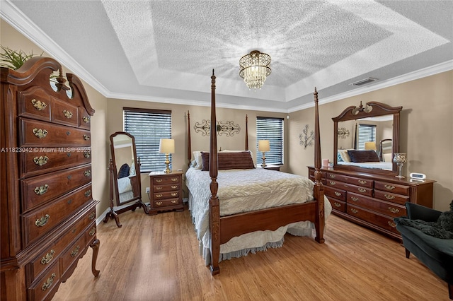 18205 NW 21st St, Pembroke Pines, FL 33029 - bedroom with a tray ceiling, a textured ceiling, light wood-style floors, a chandelier, and ornamental molding
