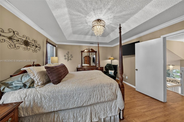 18205 NW 21st St, Pembroke Pines, FL 33029 - bedroom with wood finished floors, a raised ceiling, a chandelier, a textured ceiling, and crown molding