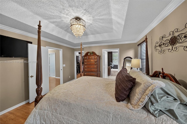 18205 NW 21st St, Pembroke Pines, FL 33029 - bedroom with a chandelier, a textured ceiling, crown molding, wood finished floors, and a tray ceiling