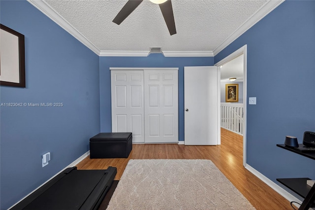 18205 NW 21st St, Pembroke Pines, FL 33029 - exercise area featuring a ceiling fan, wood finished floors, a textured ceiling, and crown molding