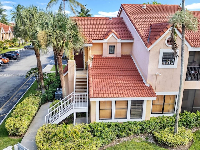 15560 SW 104th Ter Unit 611, Miami, FL 33196 - view of building exterior featuring stairway and uncovered parking