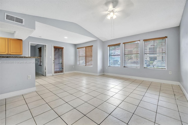 15560 SW 104th Ter Unit 611, Miami, FL 33196 - unfurnished living room featuring vaulted ceiling, plenty of natural light, light tile patterned flooring, a ceiling fan, and a textured ceiling