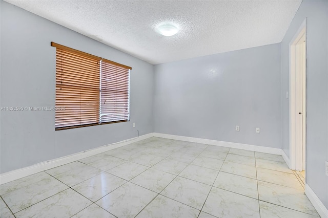 15560 SW 104th Ter Unit 611, Miami, FL 33196 - unfurnished room with a textured ceiling and baseboards