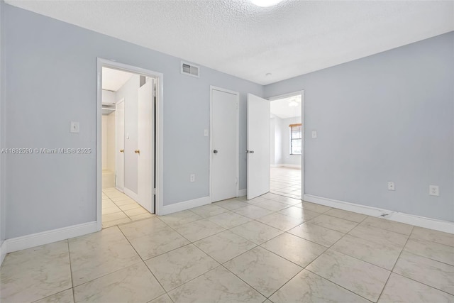 15560 SW 104th Ter Unit 611, Miami, FL 33196 - spare room with a textured ceiling and baseboards