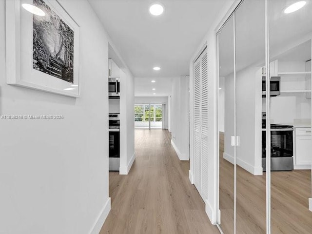 6000 NW 64th Ave Unit 303, Tamarac, FL 33319 - hallway with recessed lighting and light wood-type flooring