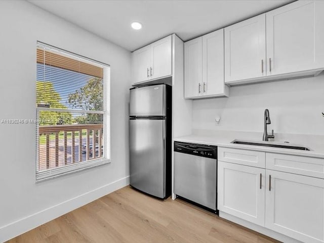 6000 NW 64th Ave Unit 303, Tamarac, FL 33319 - kitchen with appliances with stainless steel finishes, light wood-style flooring, light countertops, white cabinetry, and recessed lighting