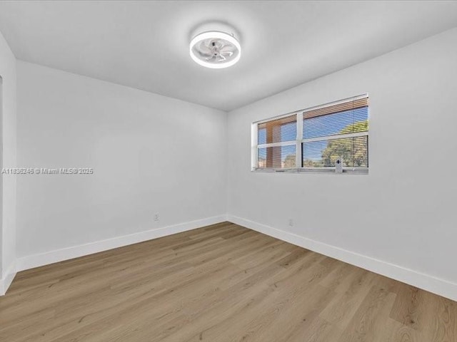 6000 NW 64th Ave Unit 303, Tamarac, FL 33319 - unfurnished room with baseboards and wood finished floors