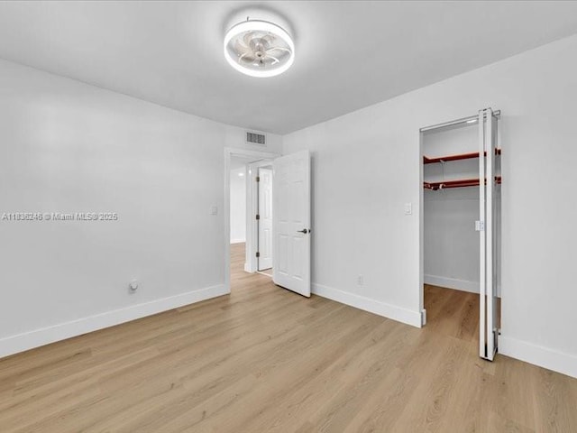 6000 NW 64th Ave Unit 303, Tamarac, FL 33319 - unfurnished bedroom with light wood finished floors and a walk in closet