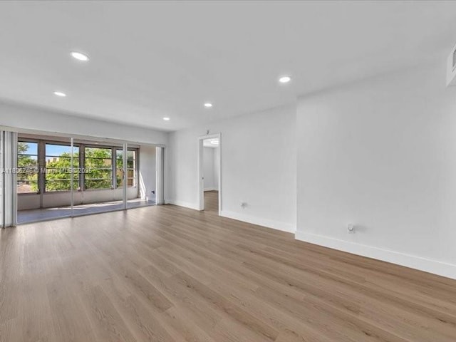 6000 NW 64th Ave Unit 303, Tamarac, FL 33319 - unfurnished room featuring wood finished floors and recessed lighting