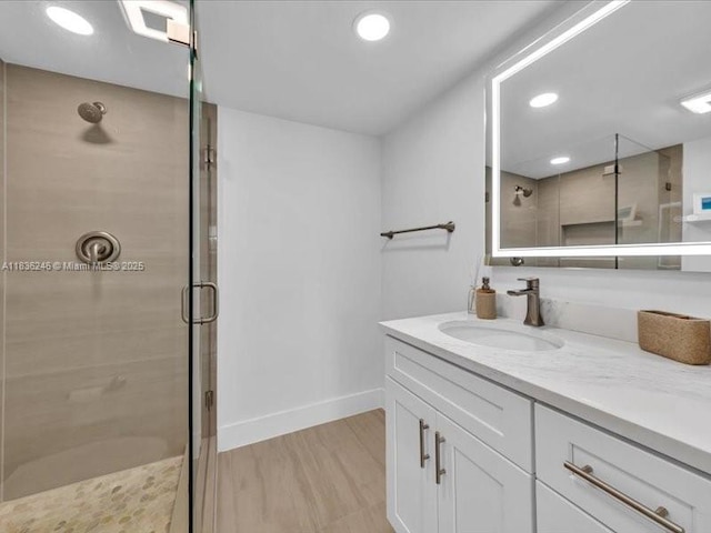 6000 NW 64th Ave Unit 303, Tamarac, FL 33319 - full bathroom with a stall shower, vanity, wood finished floors, and recessed lighting