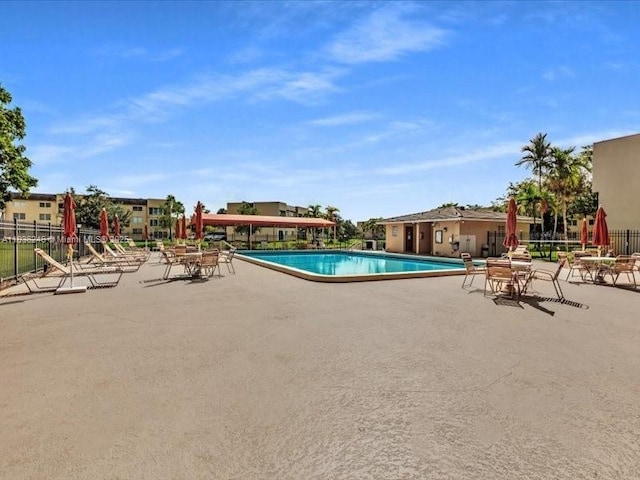 6000 NW 64th Ave Unit 303, Tamarac, FL 33319 - community pool with a patio area