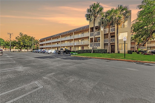 6000 NW 64th Ave Unit 303, Tamarac, FL 33319 - property at dusk featuring uncovered parking
