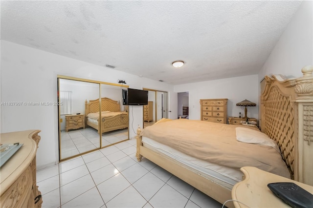 3631 SW 127th Ave, Miami, FL 33175 - bedroom with a textured ceiling, light tile patterned floors, and multiple closets