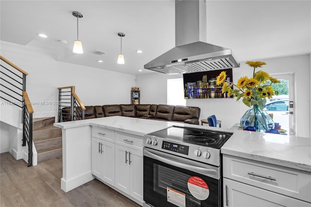 11128NW 17th Ave Unit 1-2, Miami, FL 33167 - kitchen featuring island exhaust hood, stainless steel electric stove, light wood finished floors, white cabinets, and hanging light fixtures