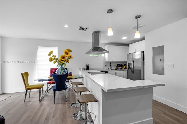 11128NW 17th Ave Unit 1-2, Miami, FL 33167 - kitchen featuring stainless steel fridge, island exhaust hood, electric panel, a peninsula, and white cabinetry
