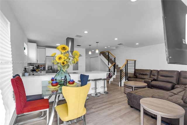11128NW 17th Ave Unit 1-2, Miami, FL 33167 - dining area featuring stairway, light wood-style flooring, and recessed lighting