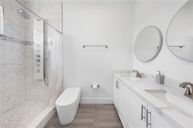 11128NW 17th Ave Unit 1-2, Miami, FL 33167 - bathroom with tiled shower, double vanity, and wood finished floors