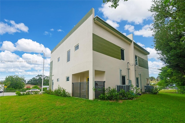 11128NW 17th Ave Unit 1-2, Miami, FL 33167 - view of property exterior with a yard and stucco siding