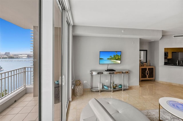 801 Brickell Key Blvd Unit 2006, Miami, FL 33131 - tiled living room featuring a water view and baseboards