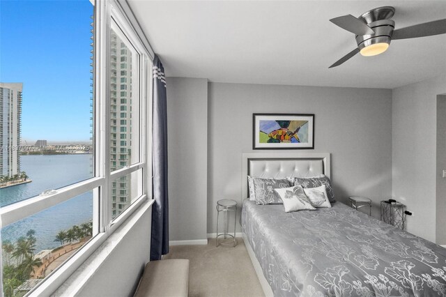 801 Brickell Key Blvd Unit 2006, Miami, FL 33131 - bedroom featuring a water view, carpet floors, and ceiling fan