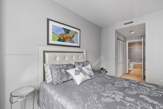 801 Brickell Key Blvd Unit 2006, Miami, FL 33131 - bedroom featuring connected bathroom, wood finished floors, and a closet